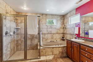 Full bath with vanity, a bath, a textured ceiling, a shower stall, and recessed lighting