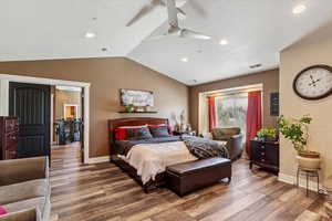 Bedroom featuring wood finished floors, vaulted ceiling, recessed lighting, and a ceiling fan