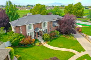 Traditional home featuring brick siding and a chimney
