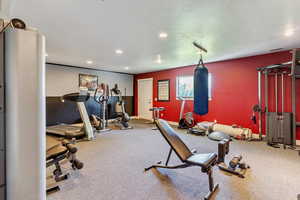 Workout room with carpet, a textured ceiling, and recessed lighting