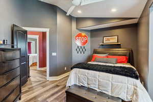 Bedroom featuring lofted ceiling, wood finished floors, and recessed lighting