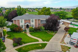View of front of house with brick siding, a residential view, and driveway