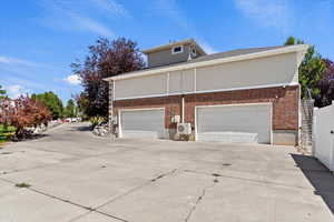 View of home's exterior with driveway and brick siding