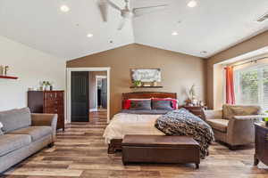 Bedroom featuring vaulted ceiling, wood finished floors, recessed lighting, and ceiling fan