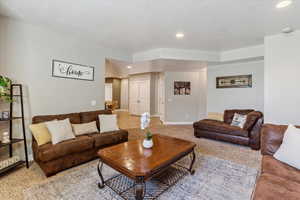 Living area featuring recessed lighting and carpet flooring
