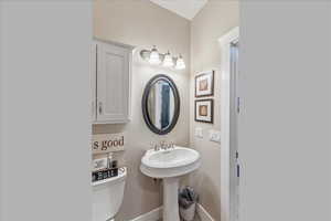 Bathroom with toilet and baseboards
