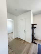 Foyer entrance featuring a textured ceiling and wood finished floors