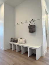 Mudroom featuring light wood finished floors and baseboards