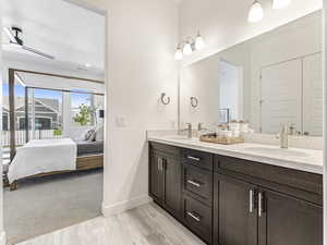 Full bath featuring ensuite bathroom, double vanity, and ceiling fan