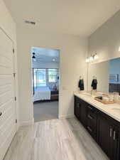 Full bathroom with ensuite bathroom, double vanity, and ceiling fan