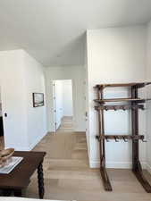 Corridor featuring light wood finished floors and a textured ceiling