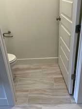 Bathroom featuring toilet and baseboards