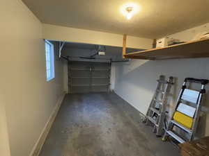 Garage featuring baseboards