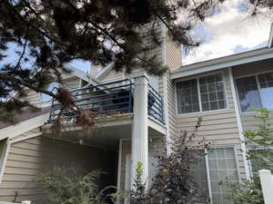 View of side of home with a balcony