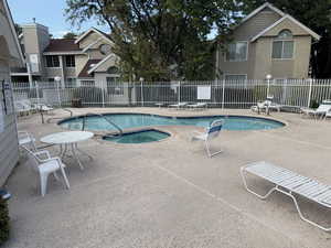 Community pool with a community hot tub and a patio area