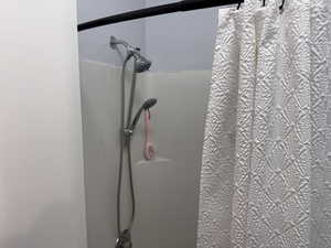 Bathroom view of curtained shower