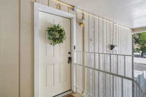 View of exterior entry with a porch