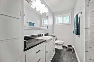 Main upstairs full bath featuring vanity and toilet.