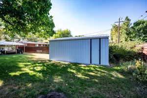 Fenced yard featuring a storage shed.