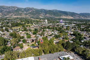 Aerial view of property's location with mountains and nearby suburban area