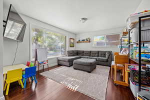 Living area with wood flooring and lots of natural light.