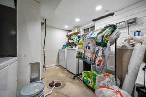 Downstairs Laundry/ utility room featuring washing machine, dryer, and water heater.