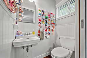 Upstairs bath with small adjacent sink and toilet.