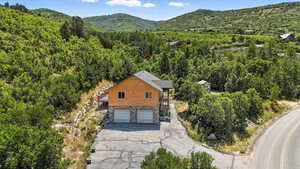 View of subject property featuring a forest and a mountain backdrop