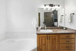 Bathroom with a jetted tub and vanity