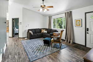 Living area with wood finished floors, a ceiling fan, and high vaulted ceiling