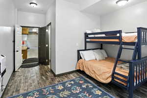 Bedroom featuring wood finished floors and baseboards