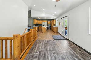 Kitchen featuring lofted ceiling, recessed lighting, stainless steel fridge with ice dispenser, light countertops, and electric range oven