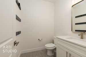 Bathroom featuring toilet and vanity, off laundry room