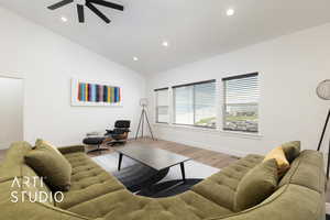 Living room featuring light wood flooring, recessed lighting, and high vaulted ceiling