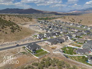 Aerial view of property's location with mountains and nearby suburban area