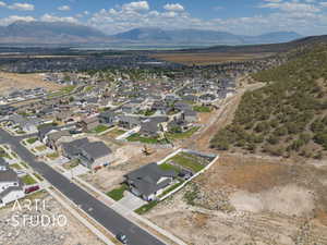 Aerial view of property's location with nearby suburban area and a lake and mountain view