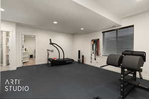 Living room configured as exercise room with an exterior entrance, kitchenette, textured ceiling, and recessed lighting