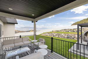 Deck featuring an outdoor living space and a mountain and lake view