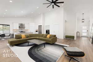 Living room with light wood-style flooring, high vaulted ceiling, recessed lighting, and washer / dryer