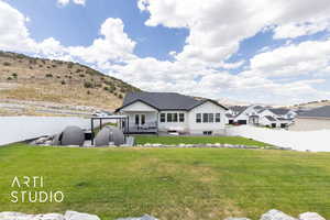 Back of house featuring a fenced backyard and a deck with mountain view