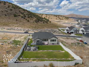 Aerial view of property and surrounding area featuring a mountain backdrop