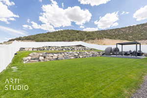 Fenced backyard featuring a patio and terraced landscaping