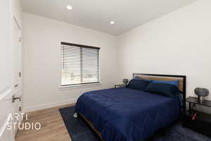 Bedroom 2  with light wood finished floors and recessed lighting and view to the North
