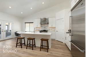 Kitchen featuring Viking appliances, lofted ceiling, a dining area, and french doors to the patio