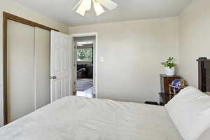 Bedroom featuring a ceiling fan and a closet