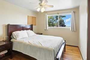 Bedroom featuring wood finished floors and a ceiling fan