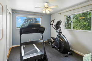 Workout room with baseboards and ceiling fan