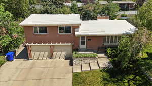 View of front of home featuring a garage, brick siding, and concrete driveway