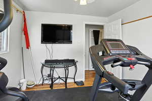 Workout room featuring wood finished floors and baseboards