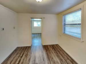 Unfurnished room with wood finished floors